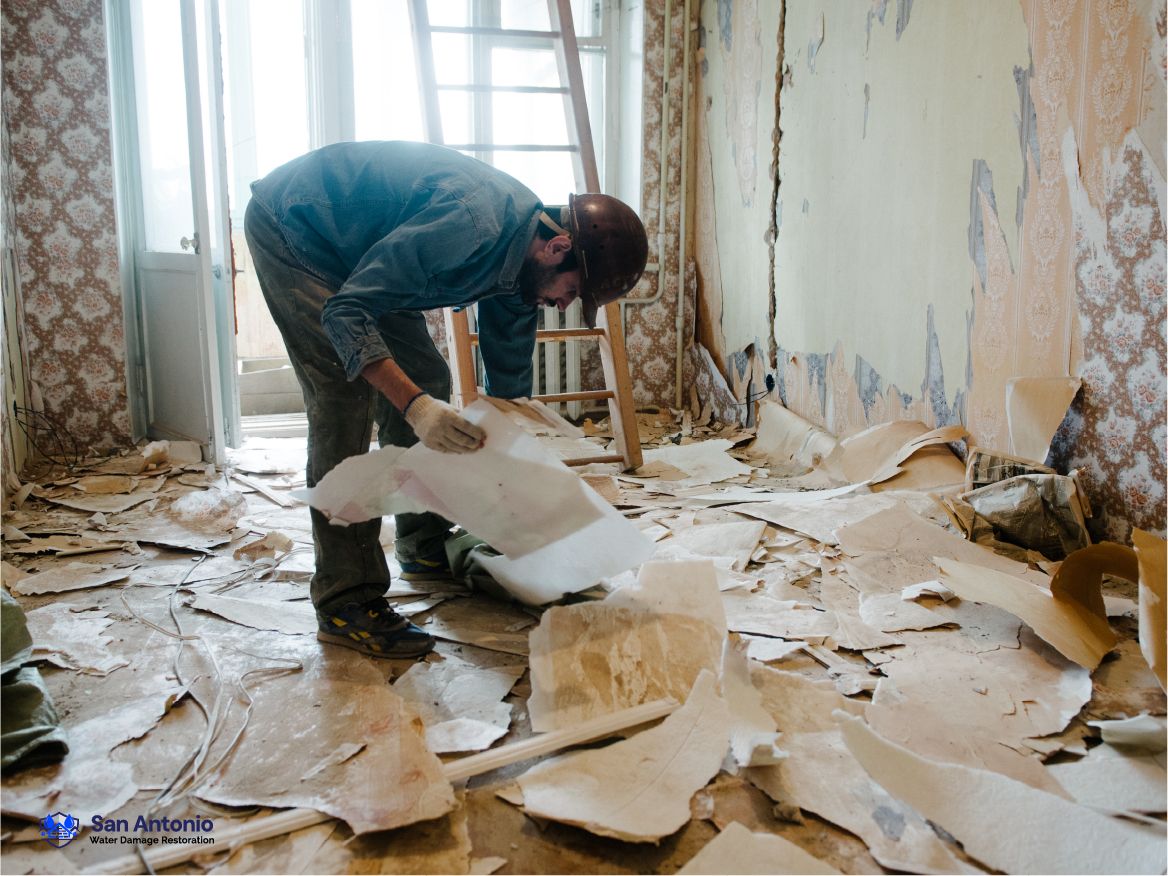 Water damage restoration crew removing damaged material in San Antonio, TX